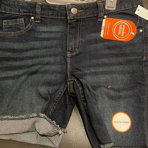 A pair of Jean shorts that go to the knee